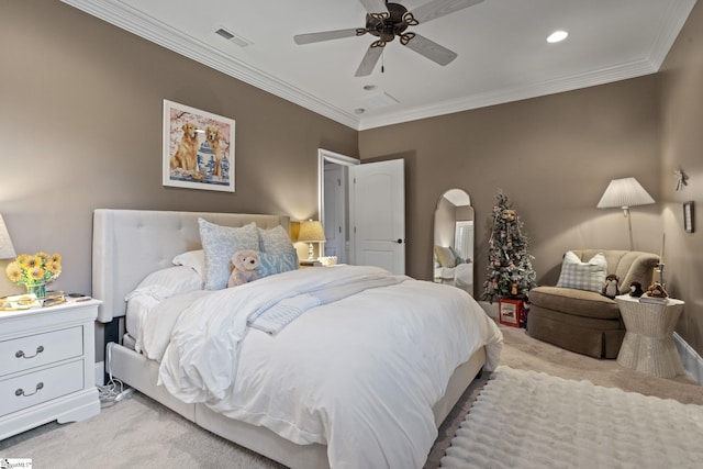 carpeted bedroom featuring ceiling fan and ornamental molding