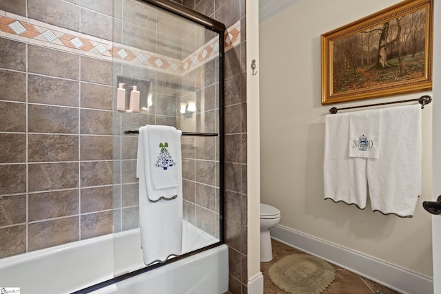 bathroom with enclosed tub / shower combo and toilet