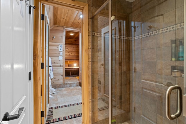 bathroom featuring wood ceiling and a shower with shower door