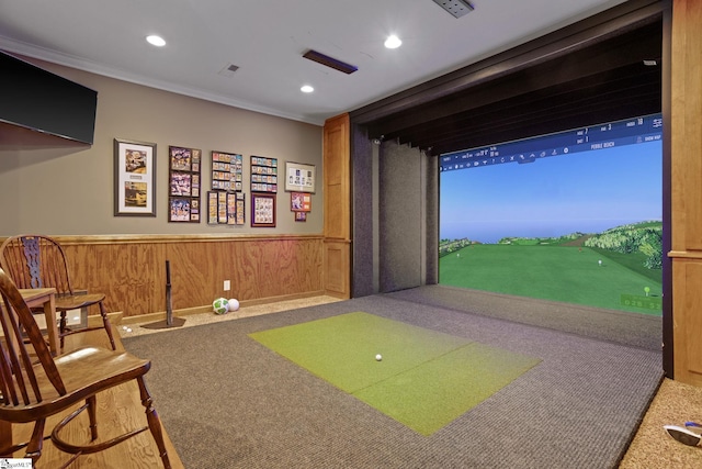 recreation room with crown molding, golf simulator, carpet flooring, and wood walls