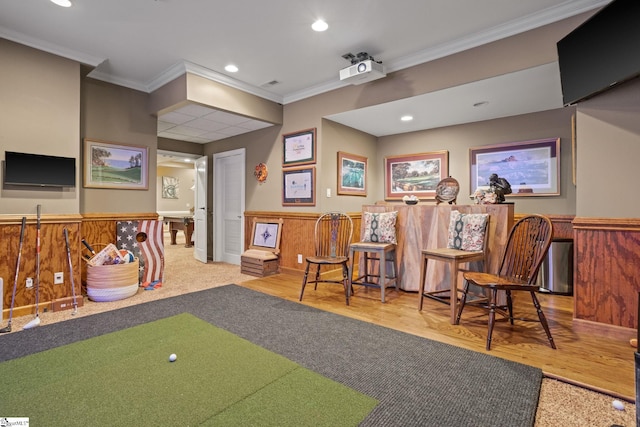 rec room with golf simulator, crown molding, wood-type flooring, and wooden walls