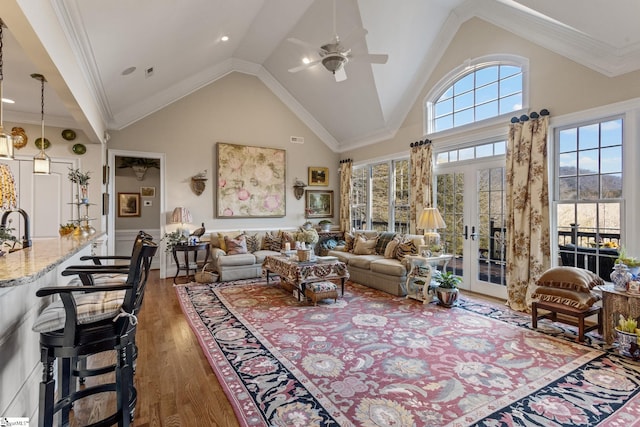 living room with dark wood-type flooring, french doors, high vaulted ceiling, ornamental molding, and ceiling fan