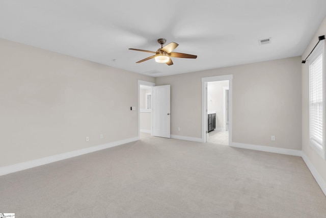 unfurnished room with light carpet and ceiling fan