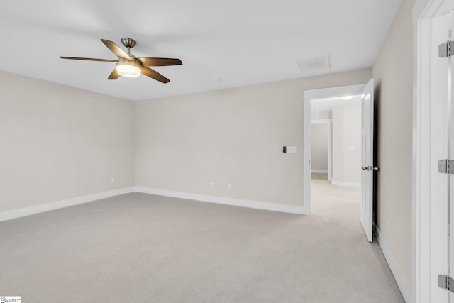 spare room featuring light carpet and ceiling fan