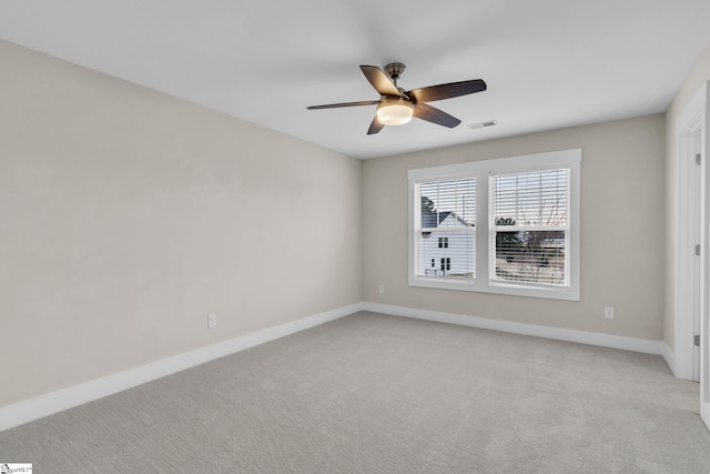 empty room with ceiling fan and light carpet