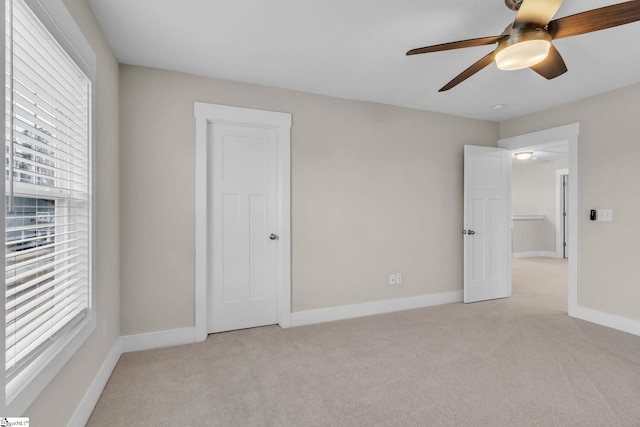 unfurnished bedroom with light colored carpet and ceiling fan