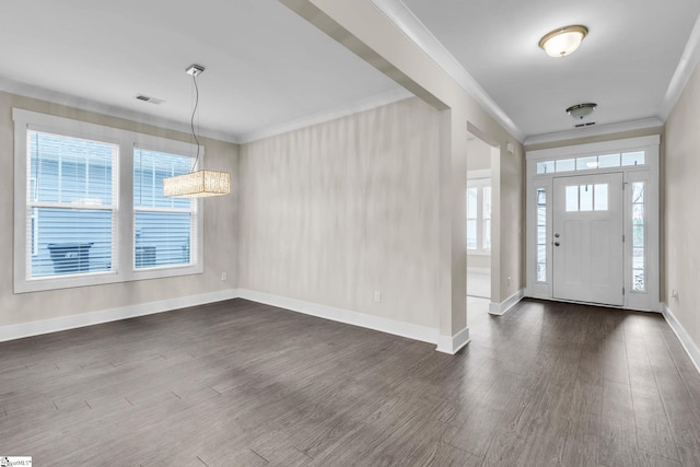 foyer featuring crown molding, plenty of natural light, and dark wood-type flooring