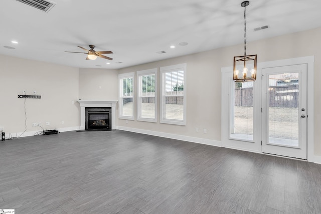 unfurnished living room with dark hardwood / wood-style floors and ceiling fan