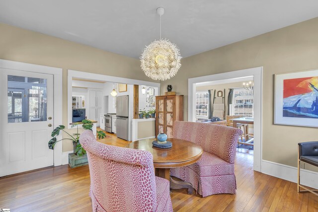 dining area featuring hardwood / wood-style floors and a chandelier