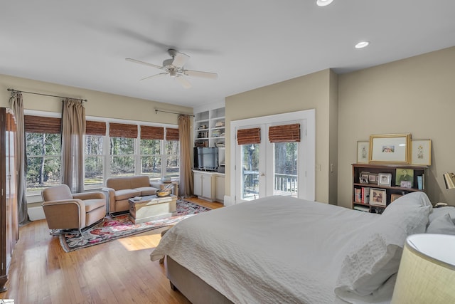 bedroom with light hardwood / wood-style flooring, access to exterior, ceiling fan, and french doors