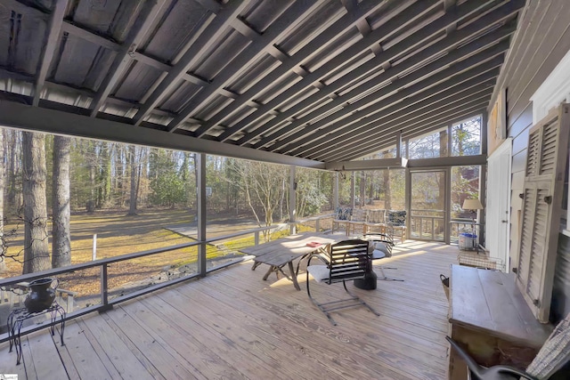 unfurnished sunroom featuring lofted ceiling