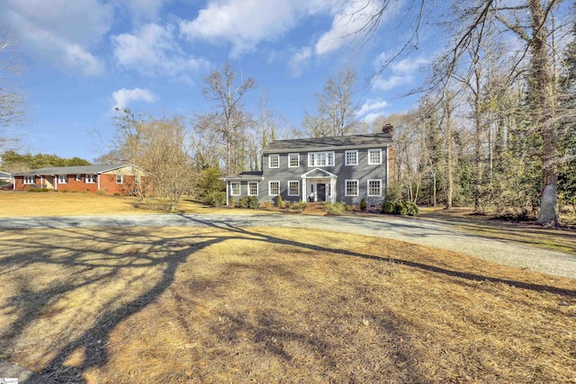 colonial inspired home featuring a front yard