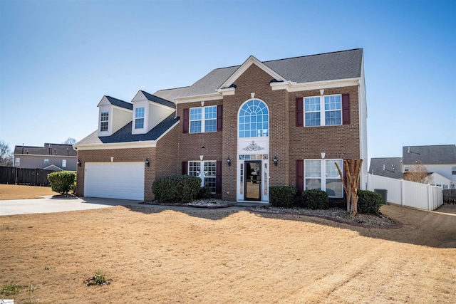 view of front of house featuring central AC unit and a garage