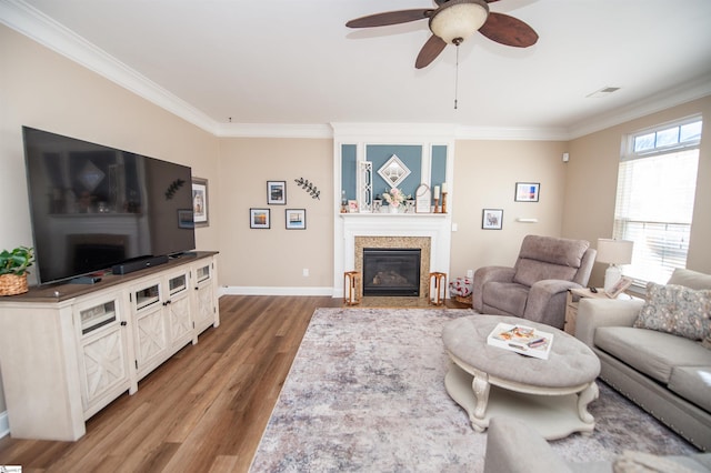 living room with ceiling fan, ornamental molding, and hardwood / wood-style floors