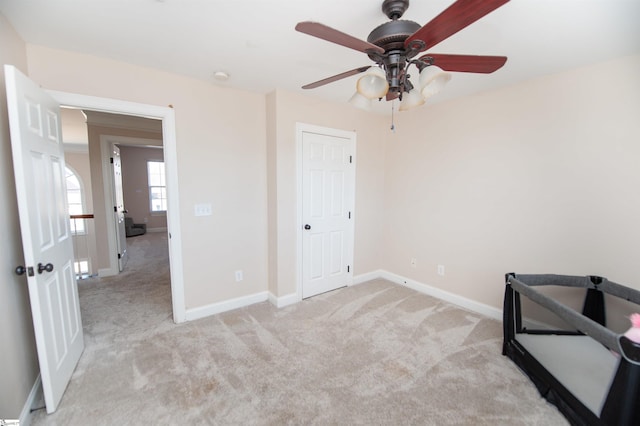 carpeted bedroom featuring ceiling fan