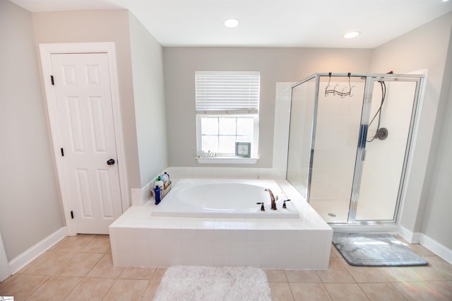 bathroom featuring tile patterned floors and independent shower and bath