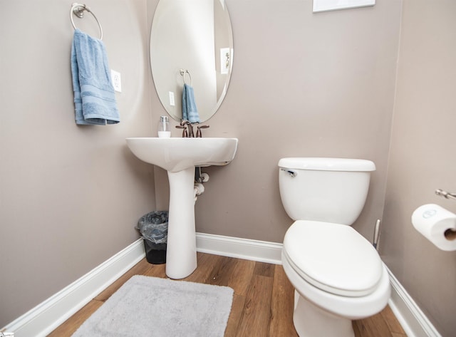 bathroom featuring hardwood / wood-style floors and toilet