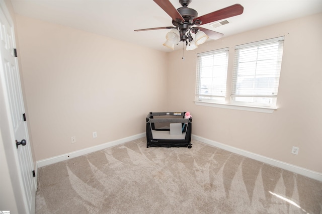 interior space featuring light colored carpet and ceiling fan