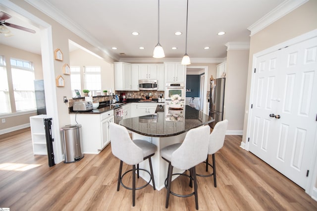 kitchen featuring white cabinetry, appliances with stainless steel finishes, sink, and pendant lighting