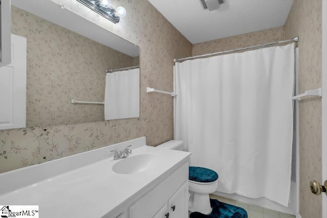 bathroom featuring vanity, toilet, and tile patterned flooring