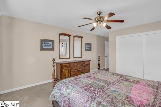 bedroom featuring ceiling fan, light colored carpet, and a closet