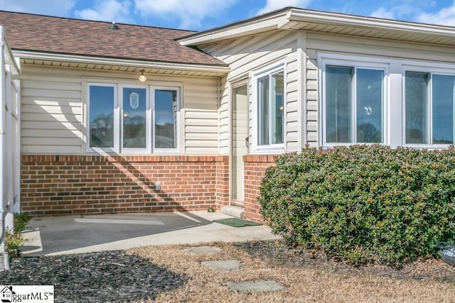 view of side of home with a patio