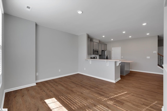 unfurnished living room featuring dark hardwood / wood-style flooring