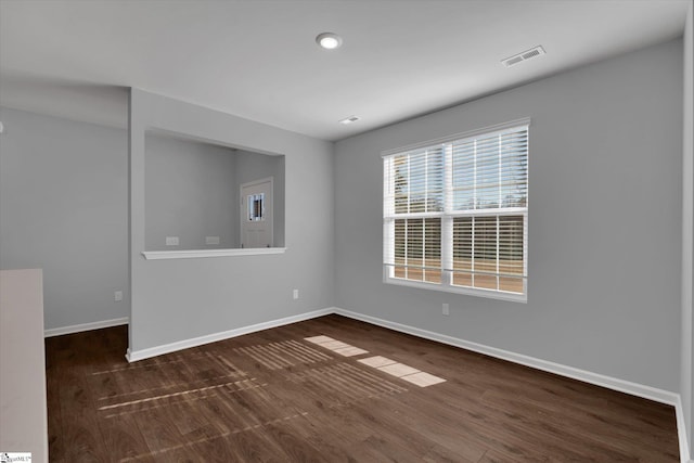 unfurnished room featuring dark wood-type flooring