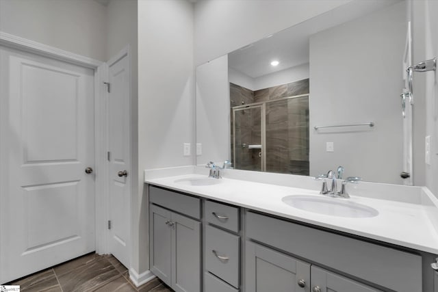 bathroom featuring vanity and a shower with door