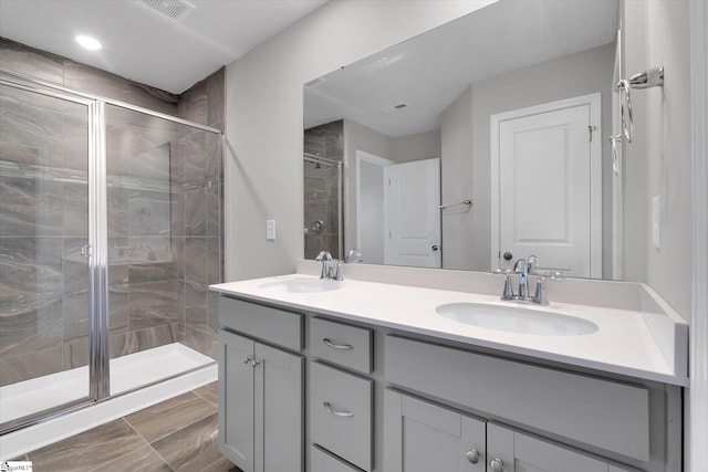 bathroom with walk in shower and vanity