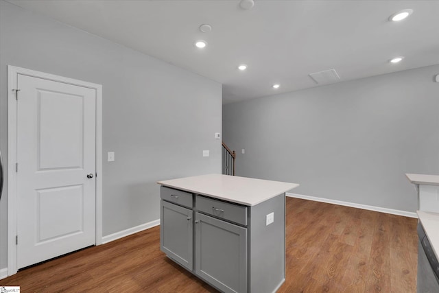 kitchen featuring gray cabinetry, light hardwood / wood-style flooring, and a kitchen island