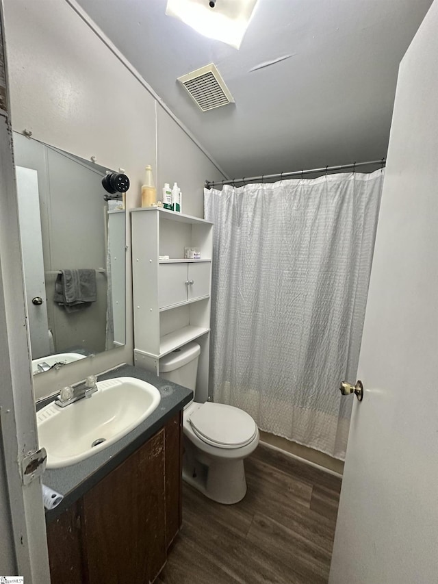 full bathroom featuring shower / bathtub combination with curtain, vanity, toilet, and hardwood / wood-style floors