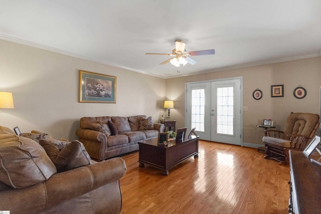 living room featuring crown molding, light hardwood / wood-style floors, french doors, and ceiling fan