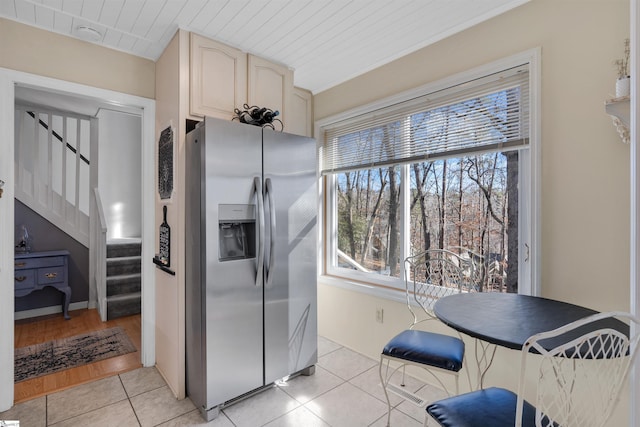 kitchen with stainless steel refrigerator with ice dispenser, wooden ceiling, and light tile patterned floors