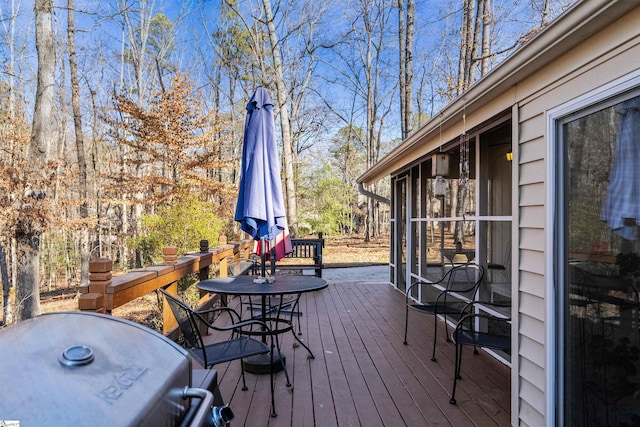 wooden deck featuring a grill