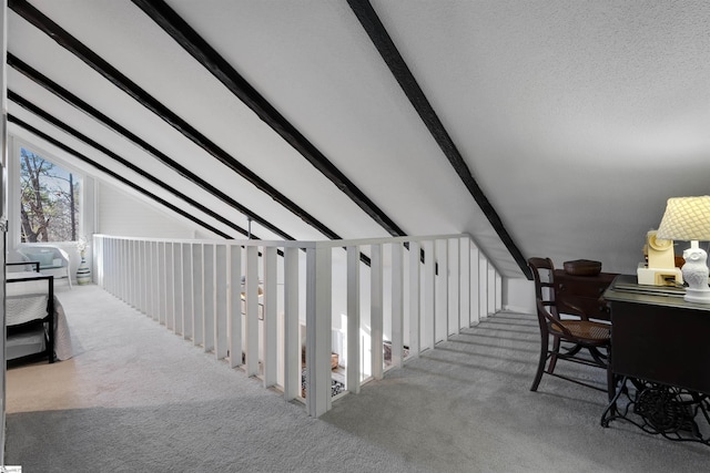 interior space featuring light colored carpet and vaulted ceiling with beams