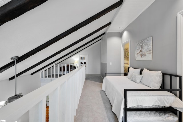 bedroom featuring vaulted ceiling with beams and light carpet