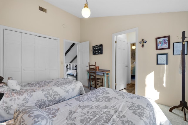 bedroom featuring lofted ceiling, carpet flooring, and a closet