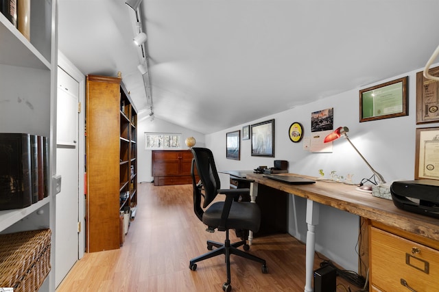 office with rail lighting, lofted ceiling, and light hardwood / wood-style flooring