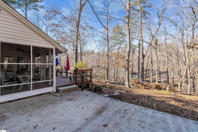 view of patio with a sunroom, ceiling fan, and a deck