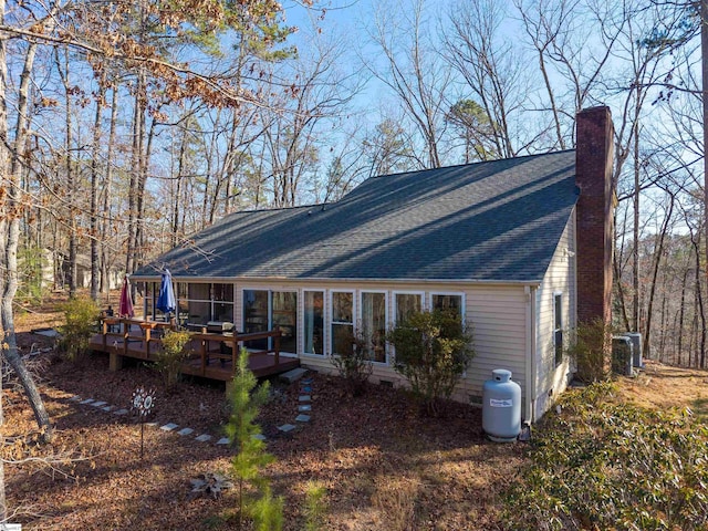 rear view of house featuring a deck