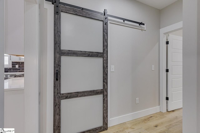 interior space featuring a barn door and light hardwood / wood-style flooring