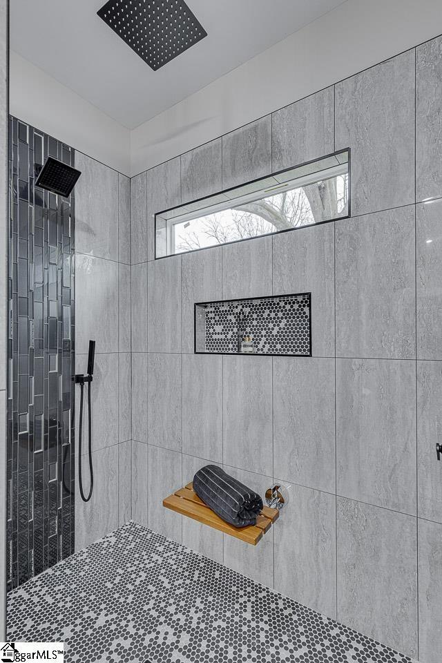 bathroom with tiled shower