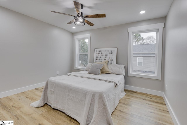 bedroom with ceiling fan and light wood-type flooring