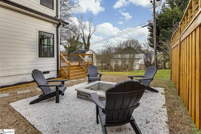 view of patio / terrace with a deck and a fire pit