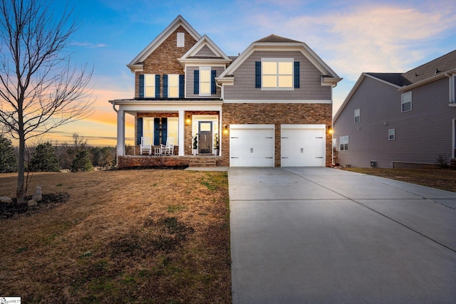 craftsman-style house with a garage, a yard, and covered porch