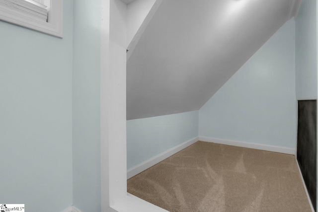 bonus room featuring vaulted ceiling and carpet flooring