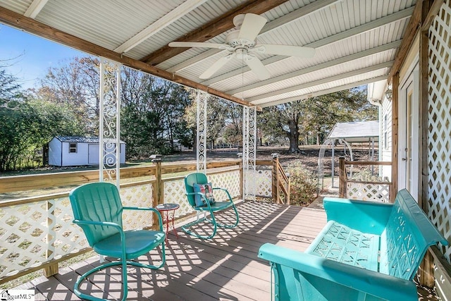 deck with ceiling fan and a storage shed