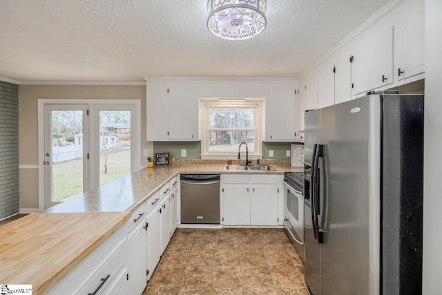 kitchen with white cabinetry, appliances with stainless steel finishes, and sink