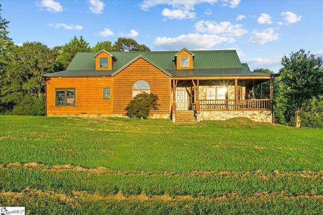 cabin featuring a front yard and covered porch